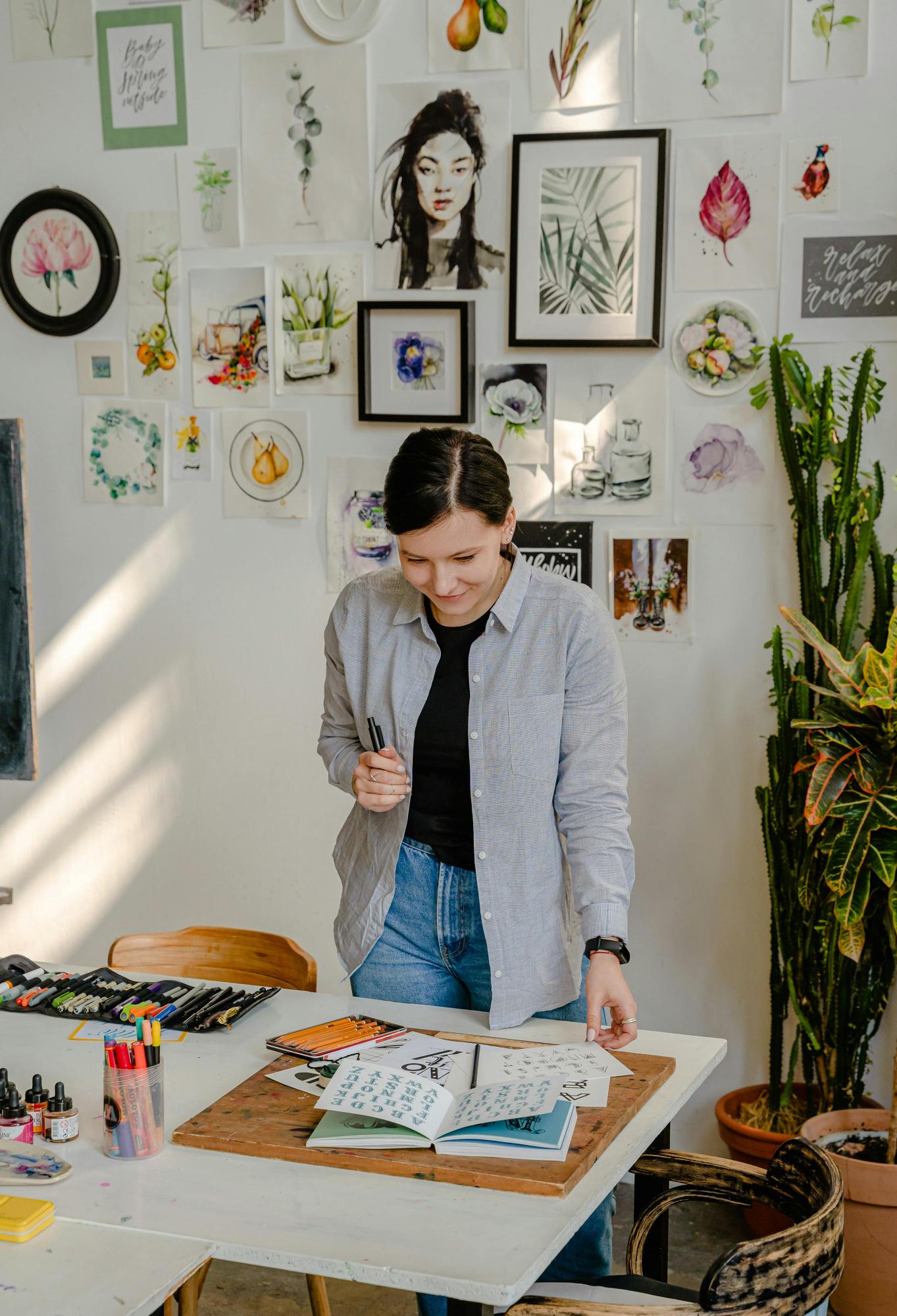 a person looking at books on a desk