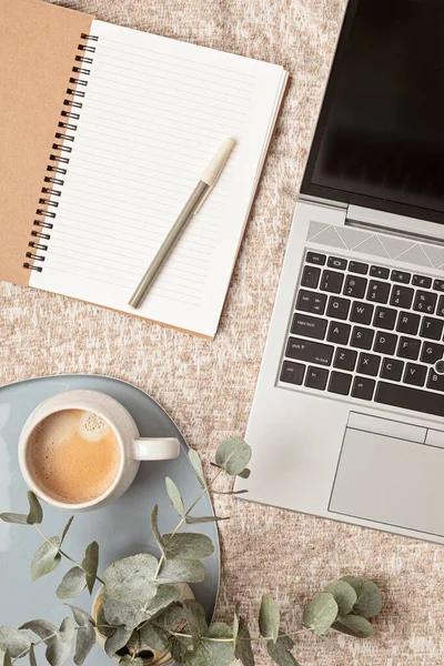 writing a book and working on a laptop
